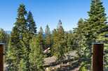 Experience breathtaking lake views and serene mountain vistas from this stunning property, nestled amidst towering pine trees.