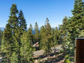 Experience breathtaking lake views and serene mountain vistas from this stunning property, nestled amidst towering pine trees.
