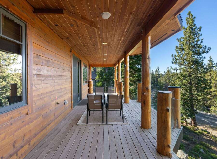 Experience the perfect blend of rustic charm and modern comfort on this expansive covered deck, ideal for enjoying the serene mountain views.