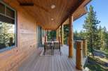 Experience the perfect blend of rustic charm and modern comfort on this expansive covered deck, ideal for enjoying the serene mountain views.