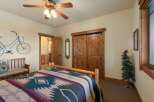 Experience rustic charm in this inviting bedroom, featuring a cozy bed adorned with a Native American-inspired blanket.