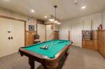 Enjoy endless entertainment in this home's dedicated game room, featuring a classic pool table perfect for friendly competitions.