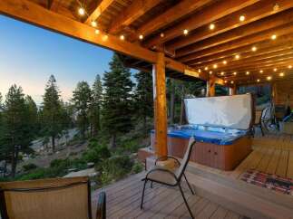 Experience ultimate relaxation on this stunning deck, complete with a luxurious hot tub offering breathtaking views of the surrounding pine forest and rolling hills.