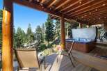 Experience ultimate relaxation on this stunning deck, featuring a luxurious hot tub with breathtaking forest and lake views.