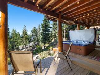Experience ultimate relaxation on this stunning deck, featuring a luxurious hot tub with breathtaking forest and lake views.