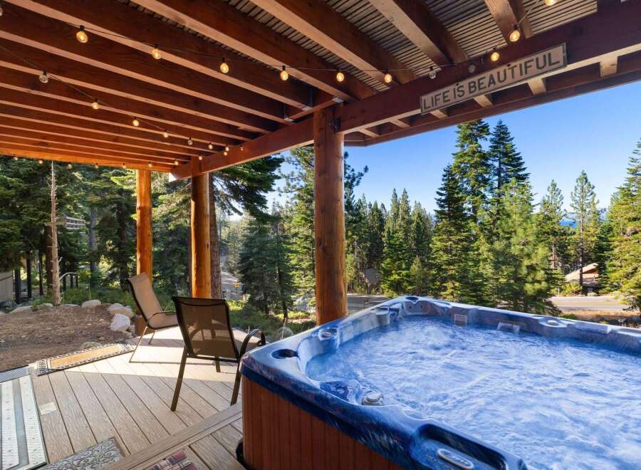 Experience ultimate relaxation in this stunning mountain retreat, featuring a luxurious hot tub perfect for soaking in the breathtaking forest views.