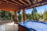 Experience ultimate relaxation in this stunning mountain retreat, featuring a luxurious hot tub perfect for soaking in the breathtaking forest views.