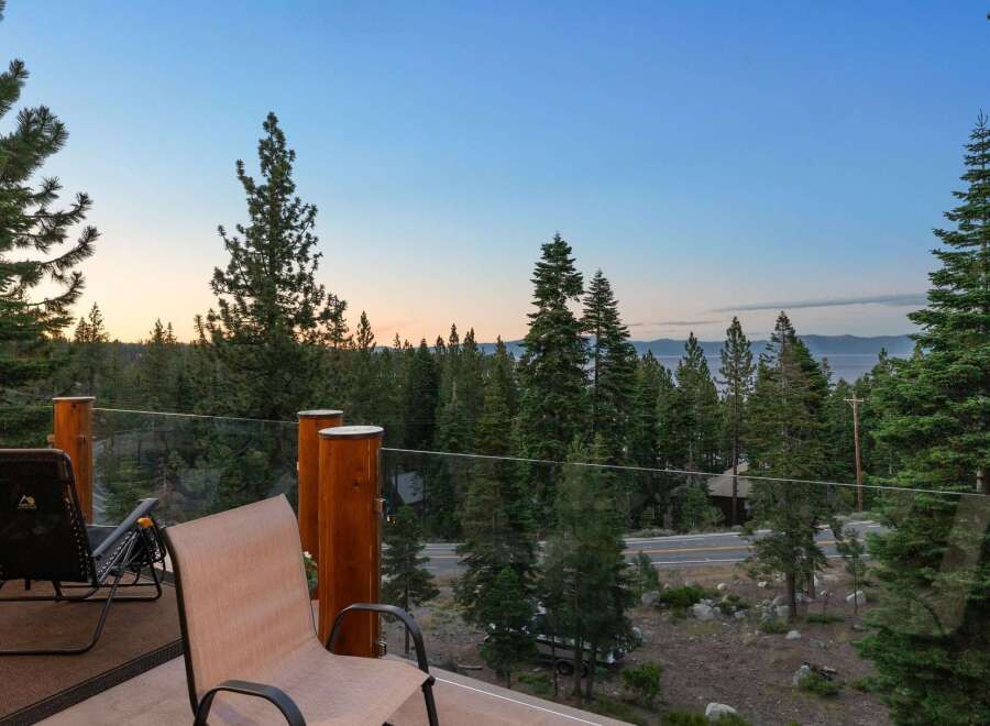 Enjoy breathtaking lake and mountain views from this stunning property's expansive deck, perfect for morning coffee or evening relaxation.