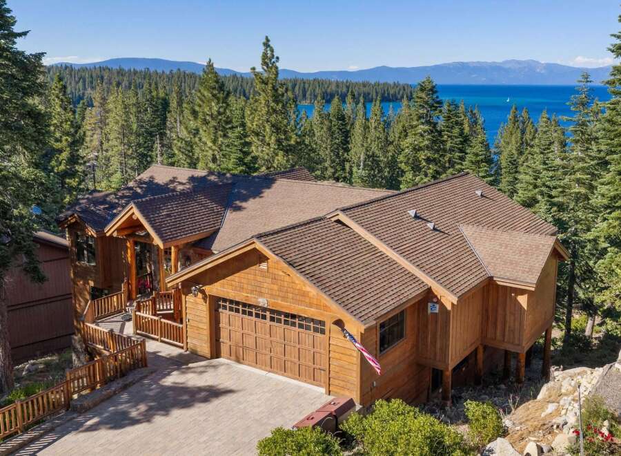 Experience luxury mountain living with this stunning timber-frame home offering breathtaking lake and mountain views.