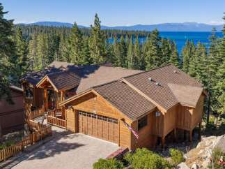 Experience luxury mountain living with this stunning timber-frame home offering breathtaking lake and mountain views.
