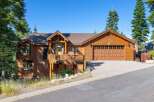 Experience rustic charm in this beautiful wooden home, featuring a spacious deck perfect for enjoying the surrounding nature.