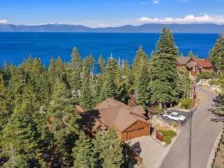 Experience breathtaking lake views from this stunning mountain retreat, nestled amidst towering pine trees.