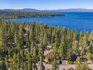 Experience the ultimate lakefront lifestyle with this stunning property nestled amidst towering pine trees.