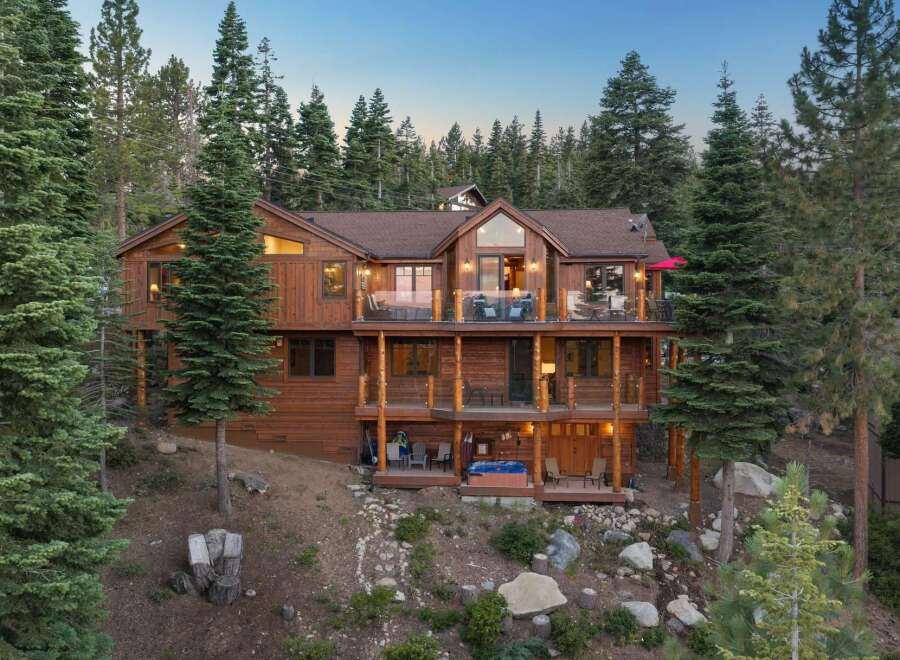 Experience luxury mountain living in this stunning multi-level wooden home nestled among tall pine trees.