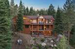 Experience luxury mountain living in this stunning multi-level wooden home nestled among tall pine trees.