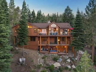 Experience luxury mountain living in this stunning multi-level wooden home nestled among tall pine trees.