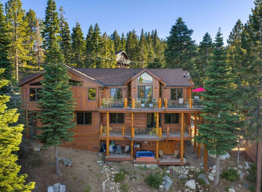 Experience luxury mountain living in this stunning multi-level wooden home nestled amidst towering pine trees.