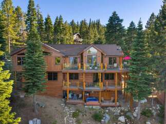 Experience luxury mountain living in this stunning multi-level wooden home nestled amidst towering pine trees.