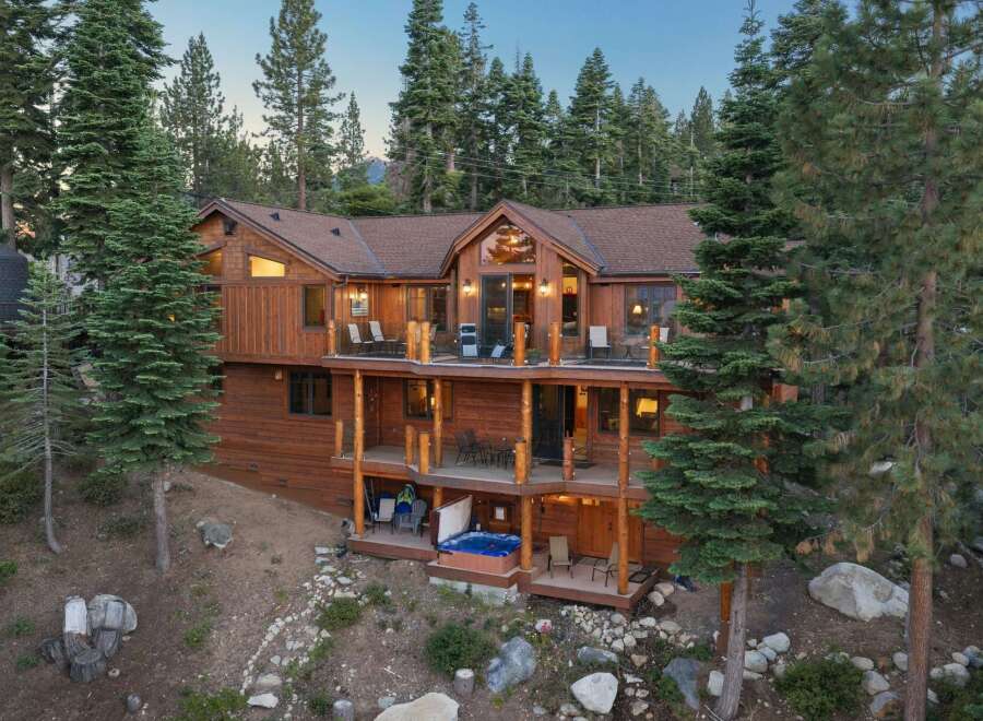 Experience luxury mountain living in this stunning multi-level wooden home nestled amongst tall pine trees.