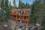 Experience luxury mountain living in this stunning multi-level wooden home nestled amongst tall pine trees.