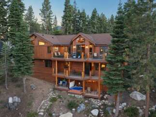 Experience luxury mountain living in this stunning multi-level wooden home nestled amongst tall pine trees.