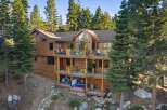 Experience luxury mountain living in this stunning wooden home nestled among tall pine trees.