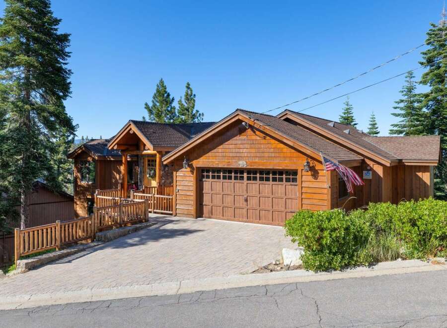 Nestled amidst tall pine trees, this charming wooden home offers a rustic mountain retreat.