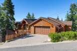 Nestled amidst tall pine trees, this charming wooden home offers a rustic mountain retreat.