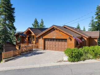 Nestled amidst tall pine trees, this charming wooden home offers a rustic mountain retreat.