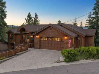 Experience mountain living in this stunning timber-framed home, nestled amongst towering pine trees.