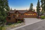 Experience rustic charm in this stunning mountain home, featuring rich wood siding and a welcoming covered porch.