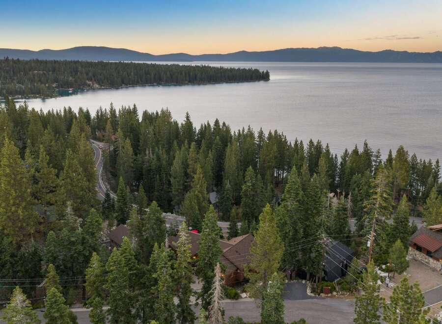 Nestled amidst towering pine trees with a breathtaking view of Lake Tahoe, this property offers a serene and private retreat.