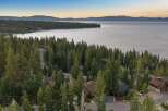 Nestled amidst towering pine trees with a breathtaking view of Lake Tahoe, this property offers a serene and private retreat.