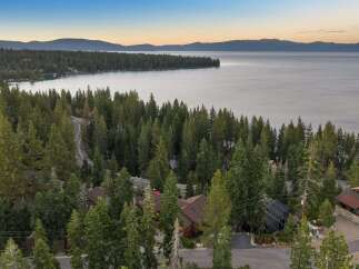 Nestled amidst towering pine trees with a breathtaking view of Lake Tahoe, this property offers a serene and private retreat.