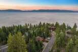 Experience breathtaking lake views from this stunning property nestled among tall pine trees.
