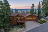 Experience breathtaking lake and mountain views from this stunning custom-built home nestled among tall pine trees.