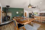Cozy living space featuring a rustic stone fireplace with a wood-burning stove, perfect for gathering on cool evenings.
