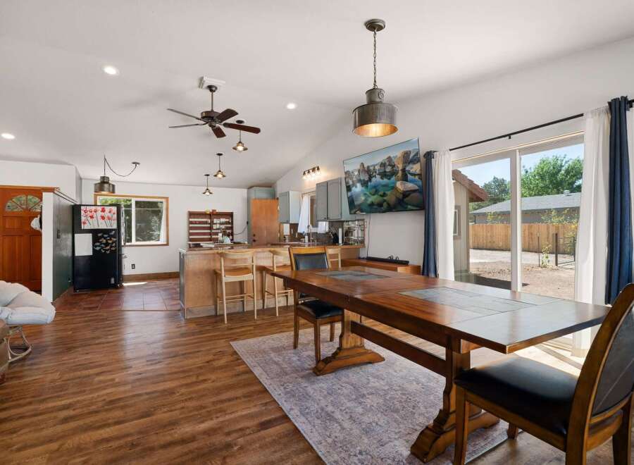 Experience open-concept living in this charming home, featuring a spacious kitchen with a breakfast bar and a dining area perfect for gatherings.