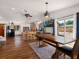 Experience open-concept living in this charming home, featuring a spacious kitchen with a breakfast bar and a dining area perfect for gatherings.
