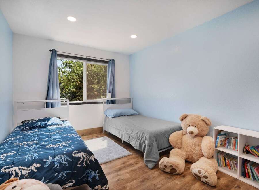 This charming bedroom features two twin beds, perfect for siblings or guests.