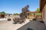 Enjoy outdoor living with this spacious backyard featuring a concrete patio, a fire pit, and a gas grill perfect for entertaining.