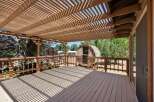 Enjoy outdoor living on this spacious wooden deck, complete with a charming wooden barrel structure perfect for relaxation or entertaining.