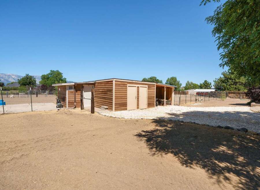 Discover this charming property featuring a versatile wooden shed, perfect for storage or a workshop.