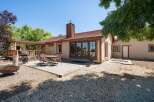 Enjoy outdoor living with this charming backyard featuring a spacious deck, a covered pergola, and a concrete patio perfect for entertaining.