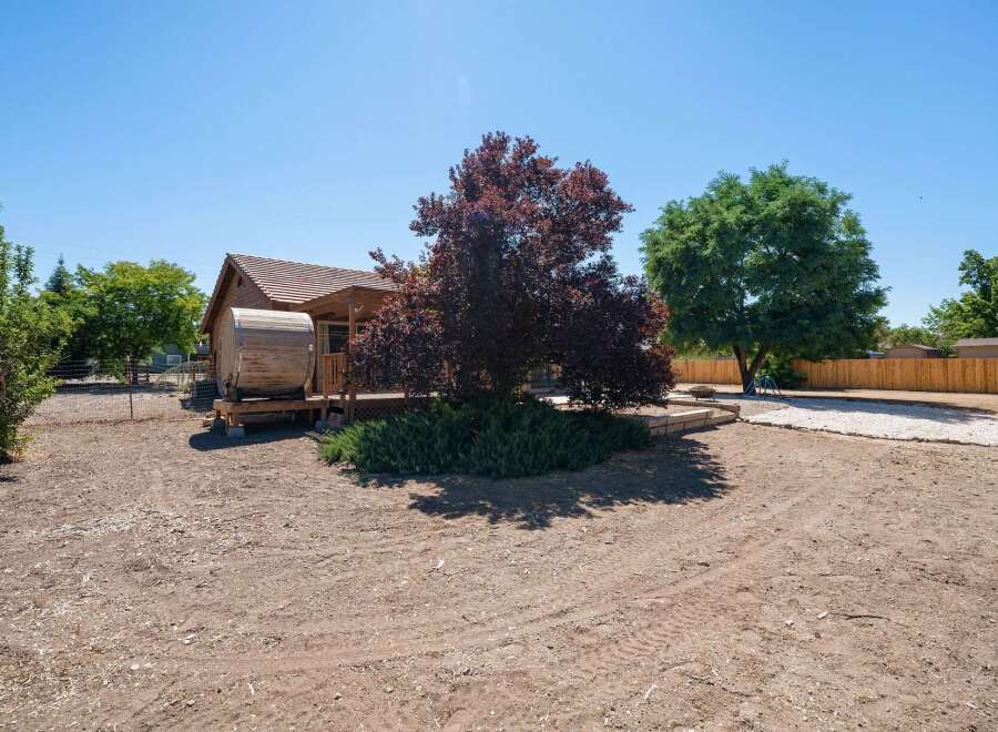 Discover unique living with this charming wooden barrel home, nestled on a spacious lot.