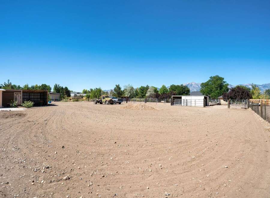 Discover this expansive property featuring a large, cleared lot perfect for equestrian activities or outdoor storage.
