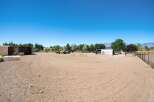 Discover this expansive property featuring a large, cleared lot perfect for equestrian activities or outdoor storage.