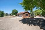 Discover this charming property featuring a detached garage with a classic tile roof and wood siding, perfect for vehicle storage or a workshop.