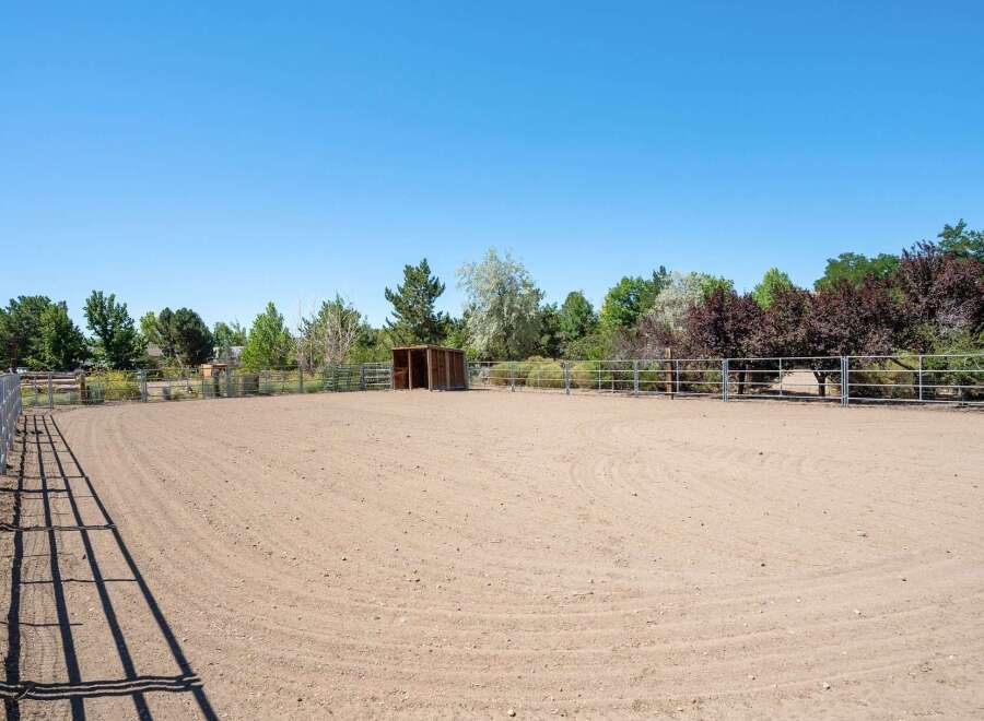 This property features a spacious outdoor riding arena, perfect for equestrian activities.