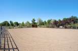 This property features a spacious outdoor riding arena, perfect for equestrian activities.